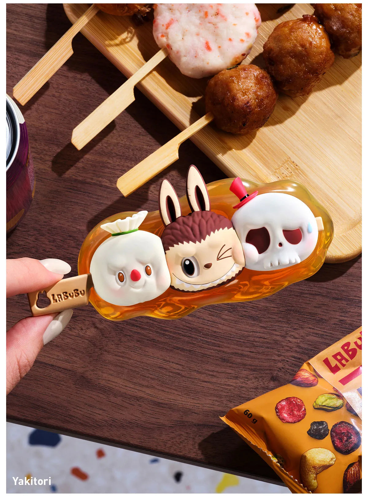 Hand holding POP MART Labubu Wacky Mart Series blind box toy with three character faces on an amber base