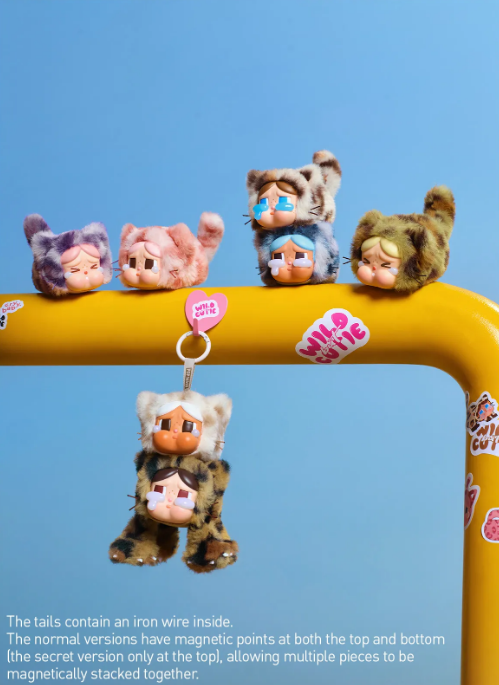 POP MART CRYBABY blind box pendant plush figures in cat costumes hanging and sitting on yellow bar