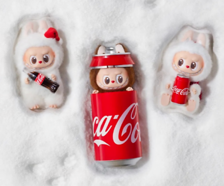 POP MART collectible figurines dressed as rabbits holding and inside Coca Cola cans on white snow