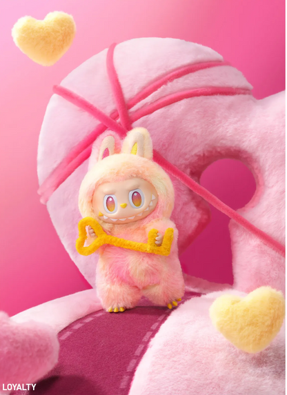 POP MART plush toy from THE MONSTERS Energy Series holding a yellow key with pink and yellow heart shapes