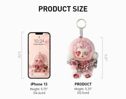 Skullpanda Winter Symphony plush keychain by POP MART next to iPhone 13 for size comparison